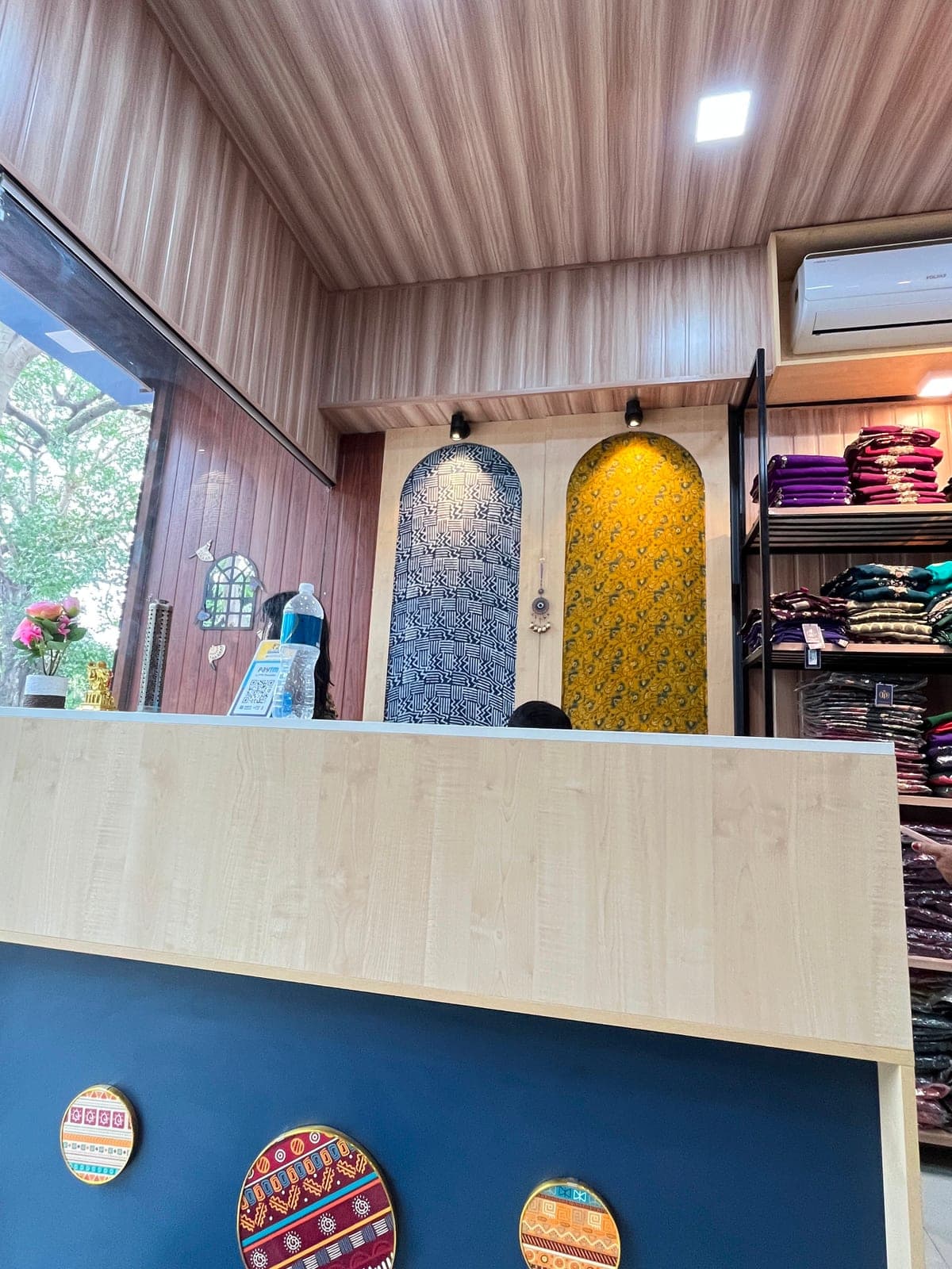 The store’s arched fabric display, mustard paisley print